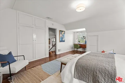 a bed room with a bed and a chair