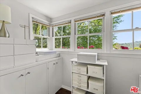 a view of cabinets a sink and a window