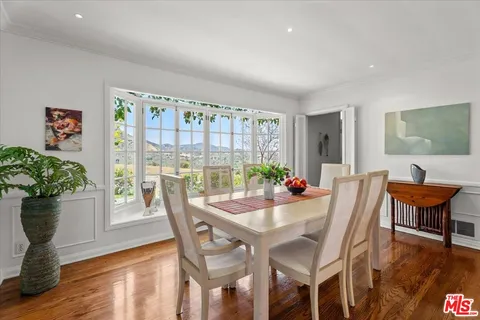 a dining room with furniture and wooden floor