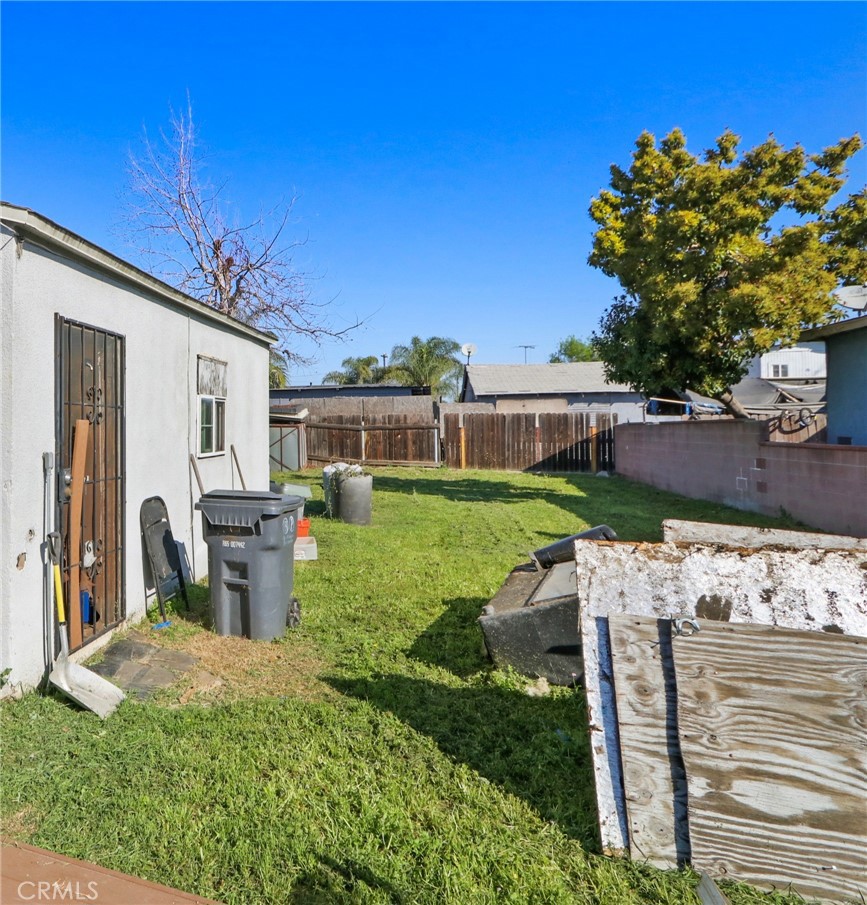 229 East Reeve Street Compton, CA 90220 - Photo 11 of 11 a view of a patio with table and chairs and potted plants