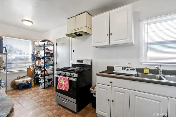 a kitchen with stainless steel appliances granite countertop a stove and a sink