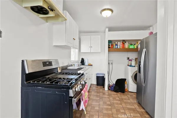 a kitchen with stainless steel appliances granite countertop a stove and a refrigerator