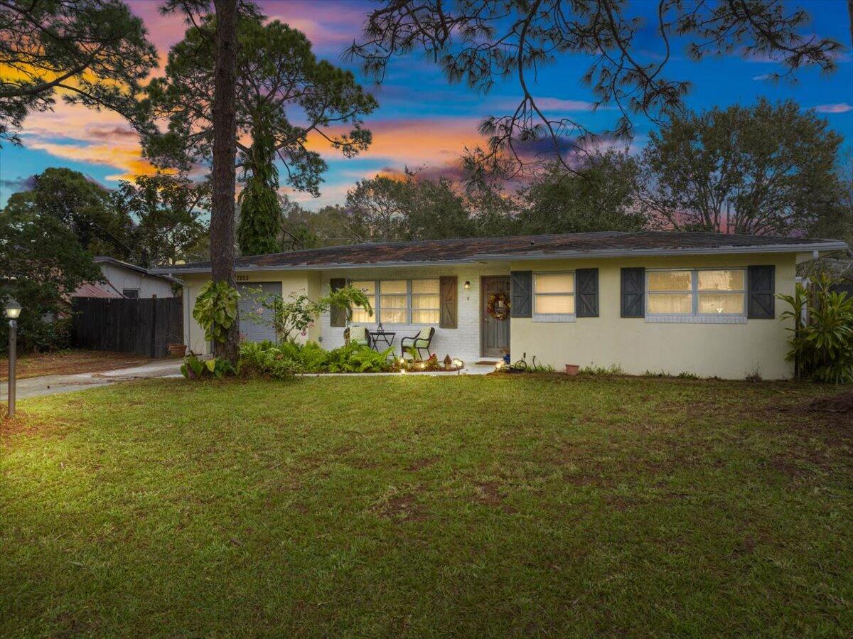 7202 Donlon Road Fort Pierce, FL 34951 - Photo 1 of 33 a front view of a house with garden