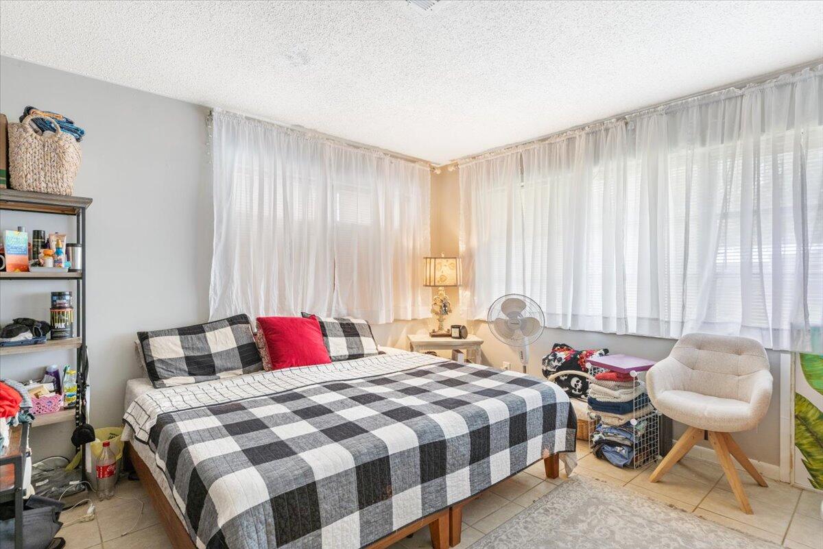 7202 Donlon Road Fort Pierce, FL 34951 - Photo 11 of 33 a bedroom with a bed and potted plant