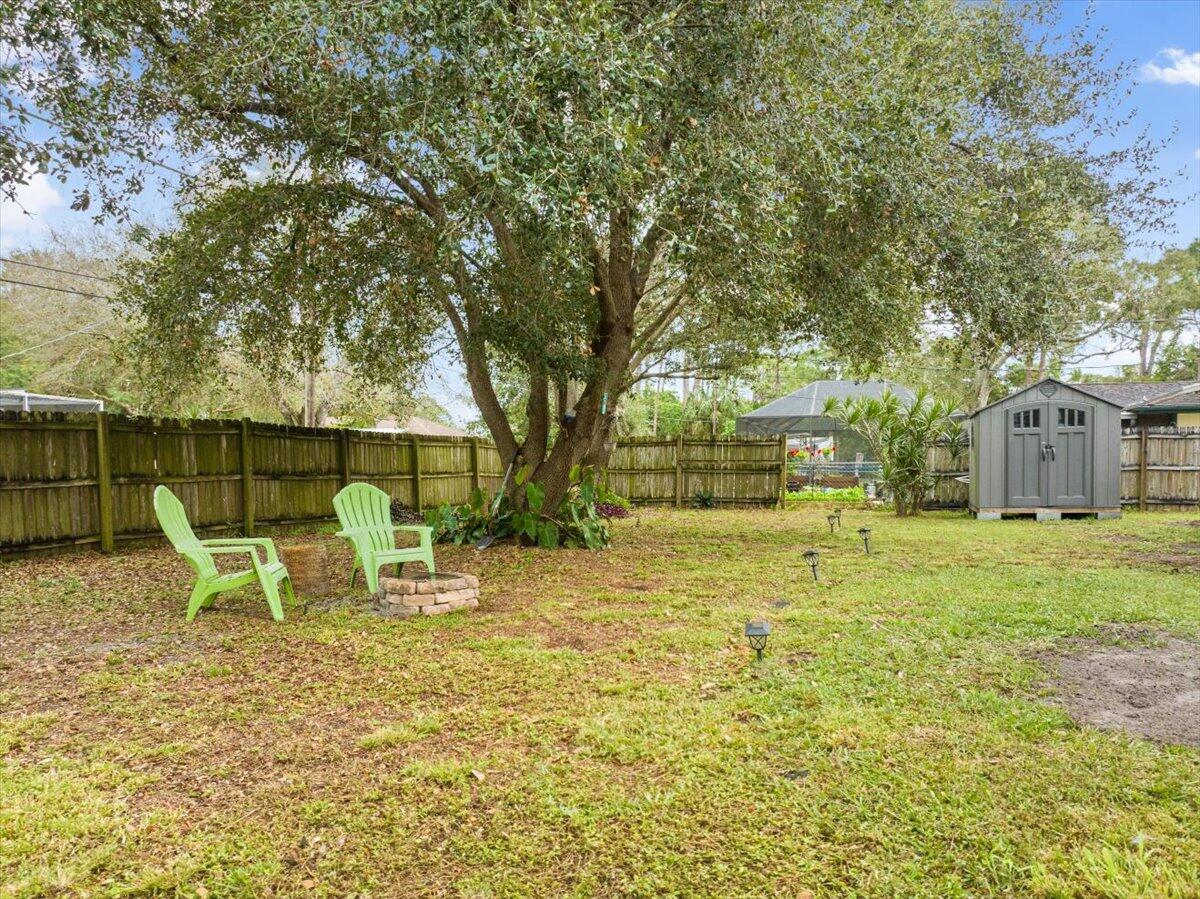 7202 Donlon Road Fort Pierce, FL 34951 - Photo 15 of 33 a view of backyard with table and chairs and wooden fence