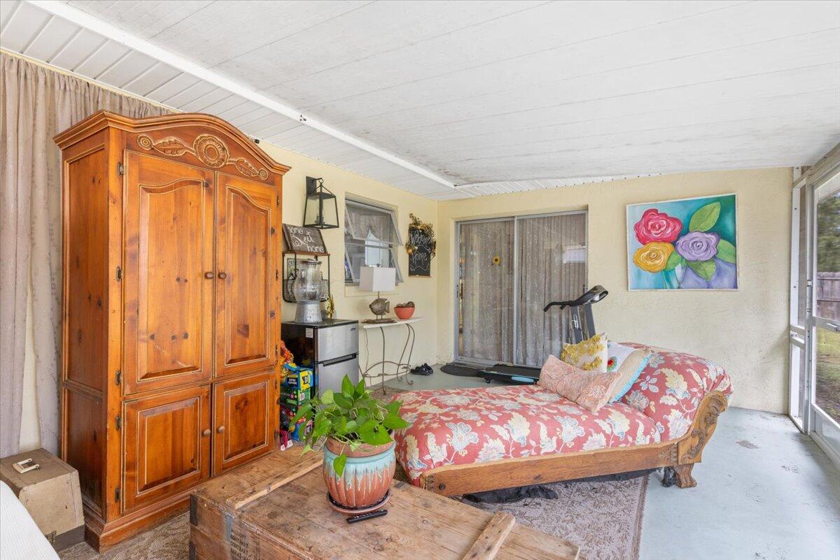 7202 Donlon Road Fort Pierce, FL 34951 - Photo 18 of 33 a bedroom with furniture and a potted plant