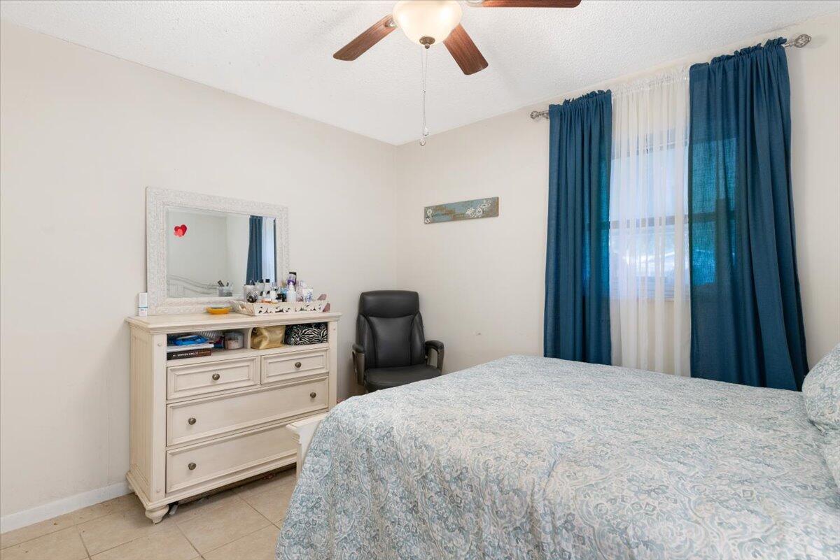 7202 Donlon Road Fort Pierce, FL 34951 - Photo 24 of 33 a bedroom with a bed and a dresser