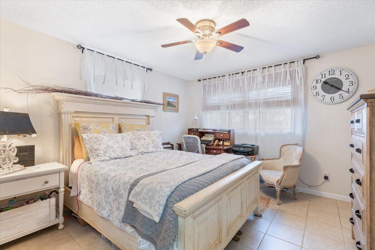 7202 Donlon Road Fort Pierce, FL 34951 - Photo 26 of 33 a bedroom with a bed and a chandelier