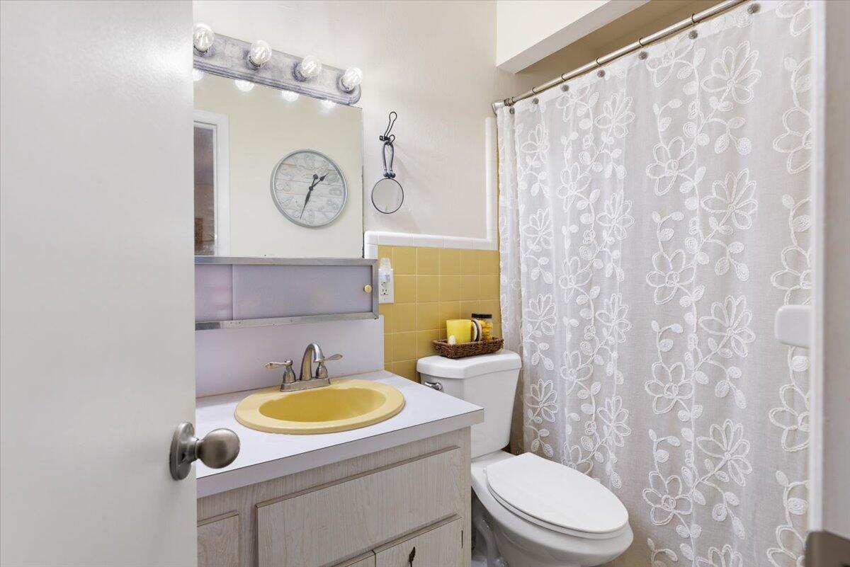 7202 Donlon Road Fort Pierce, FL 34951 - Photo 28 of 33 a bathroom with a toilet sink vanity and mirror