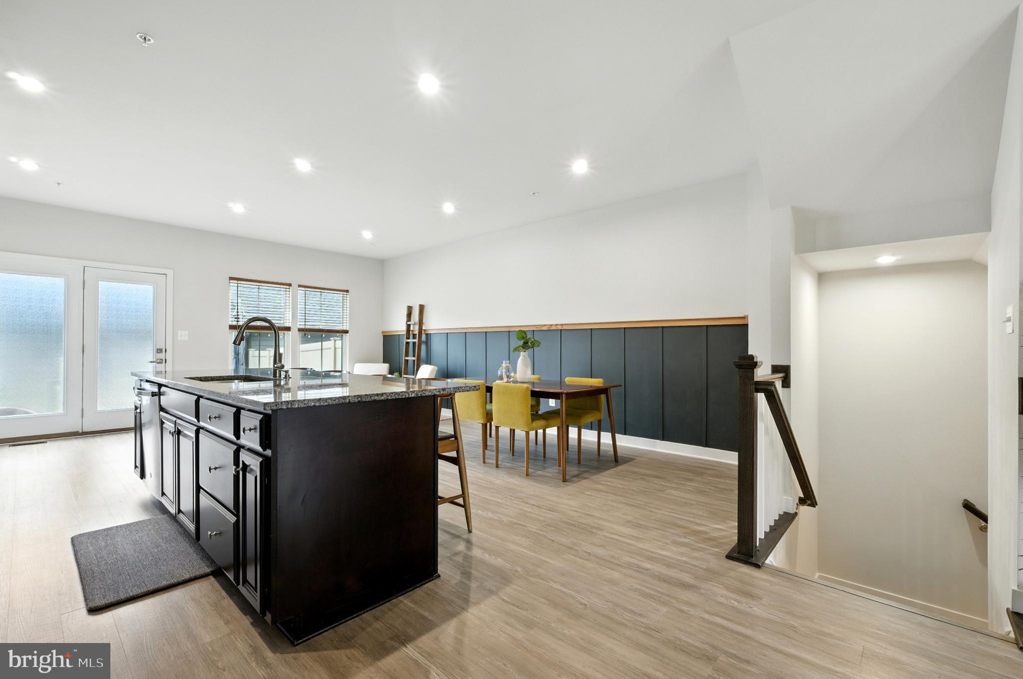 6412 Dalston Street Middle River, MD 21220 - Photo 18 of 53 a kitchen with stainless steel appliances kitchen island granite countertop a table and chairs in it
