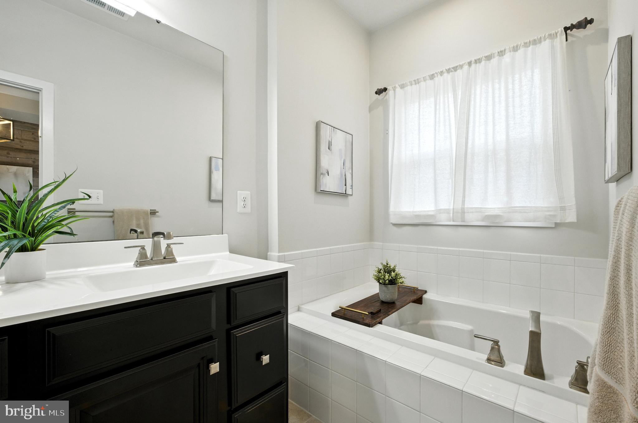 6412 Dalston Street Middle River, MD 21220 - Photo 33 of 53 a bathroom with a sink a vanity and a mirror