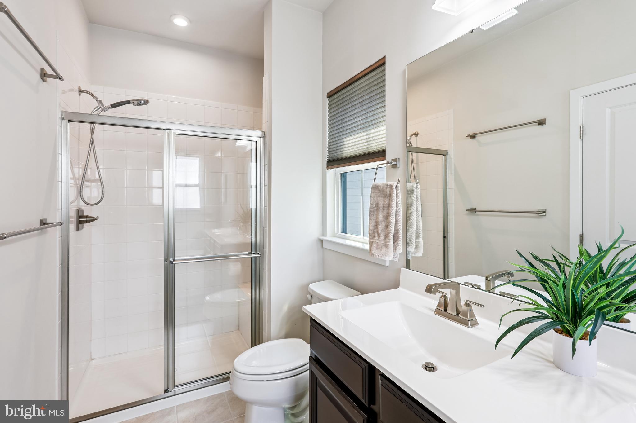 6412 Dalston Street Middle River, MD 21220 - Photo 34 of 53 a bathroom with a granite countertop sink toilet a mirror and shower