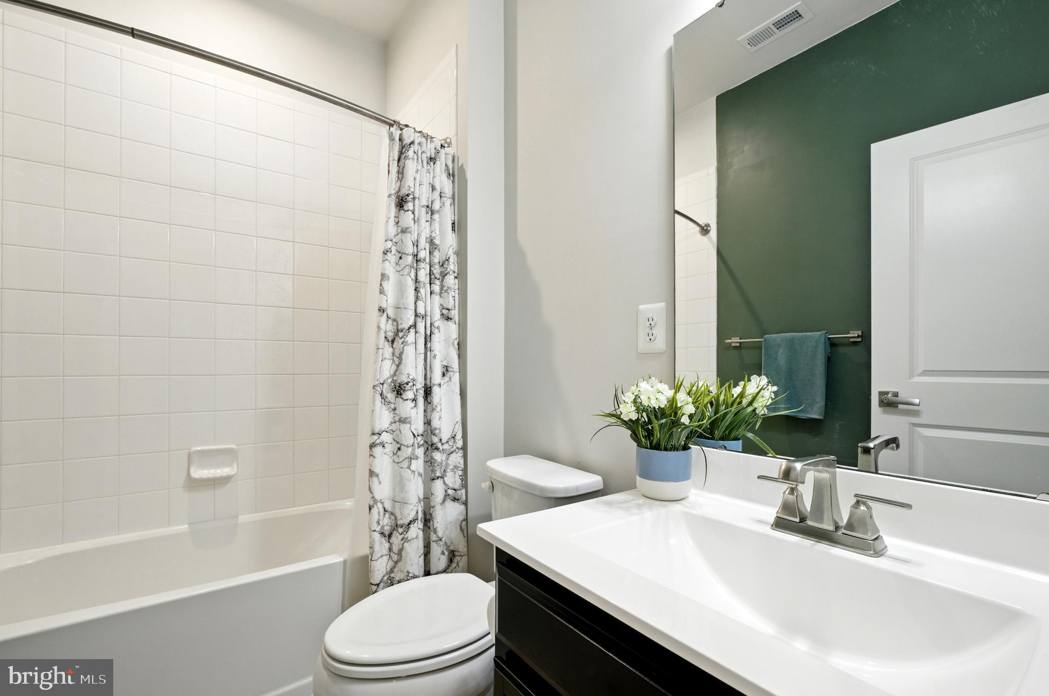 6412 Dalston Street Middle River, MD 21220 - Photo 37 of 53 a bathroom with a sink a toilet a tub and shower