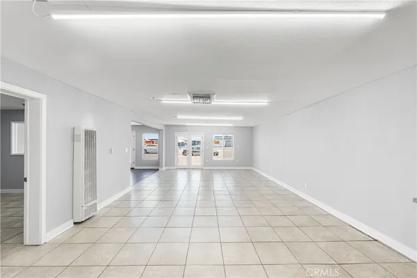 a view of a white house with a large space