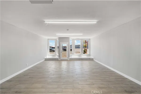 a view of an empty room and wooden floor