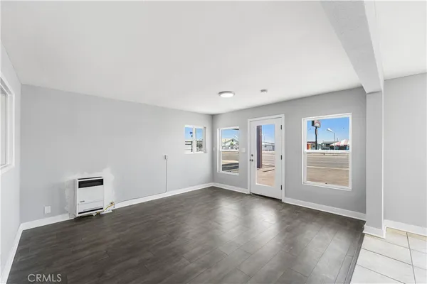 a view of an empty room and wooden floor