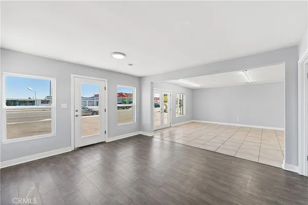 a view of an empty room with window and cabinet