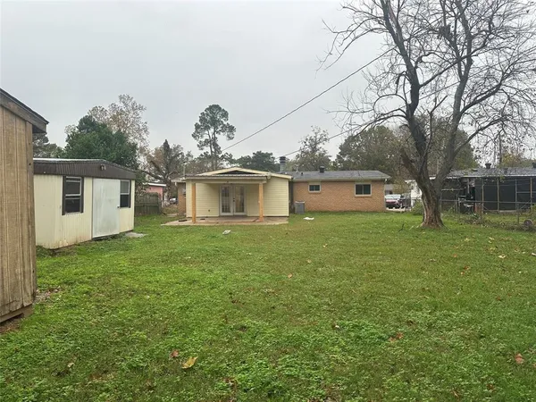 a front view of house with yard and trees