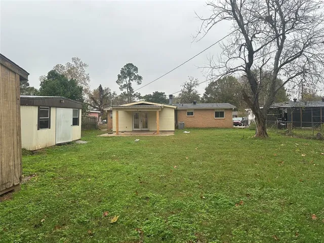 a front view of house with yard and trees