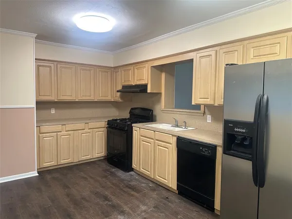 a kitchen with a sink stove and refrigerator