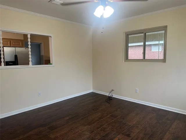 a view of a room that has wooden floor and chandelier