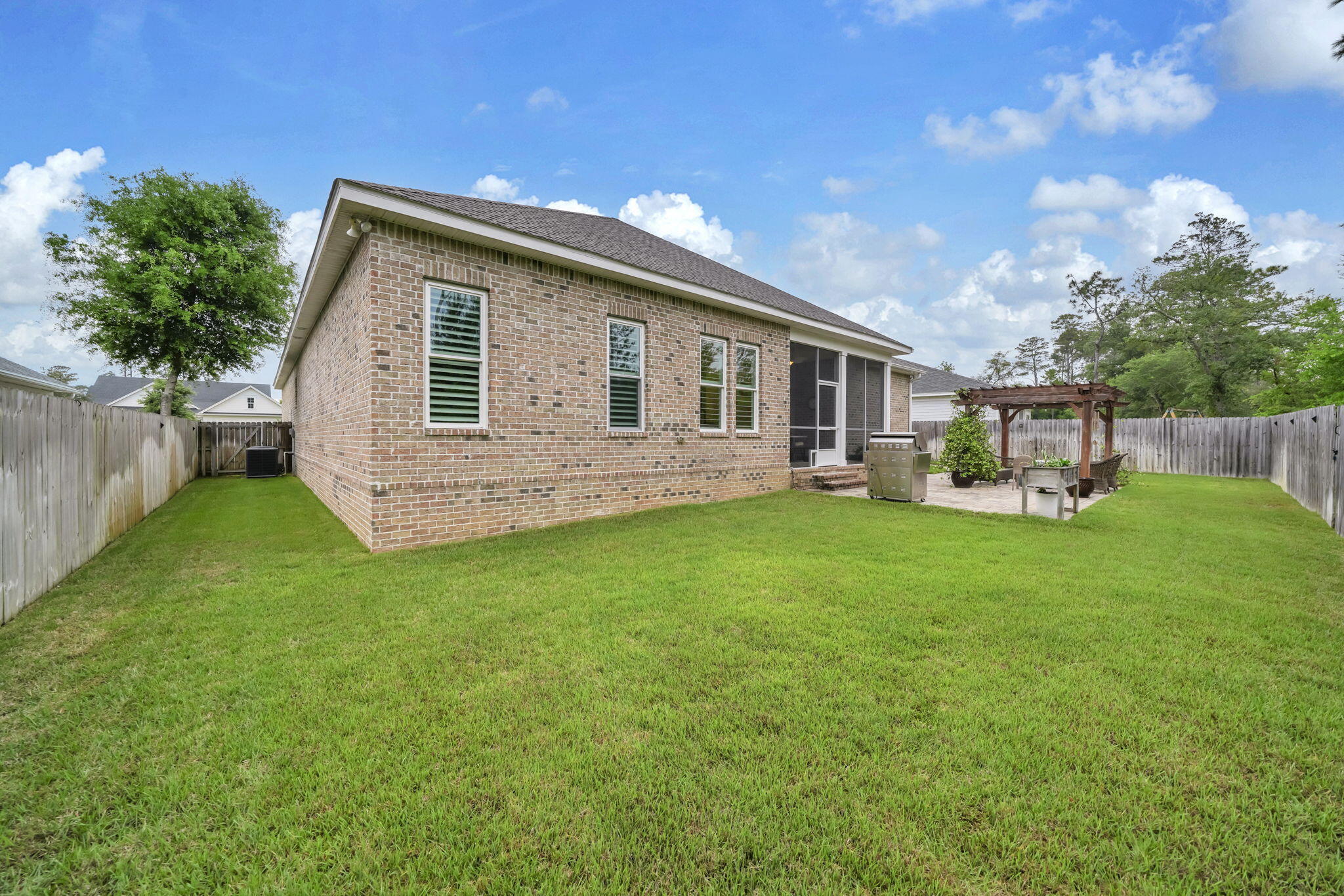 1166 Deer Moss Loop Niceville, FL 32578 - Photo 40 of 46 a front view of house with backyard and green space