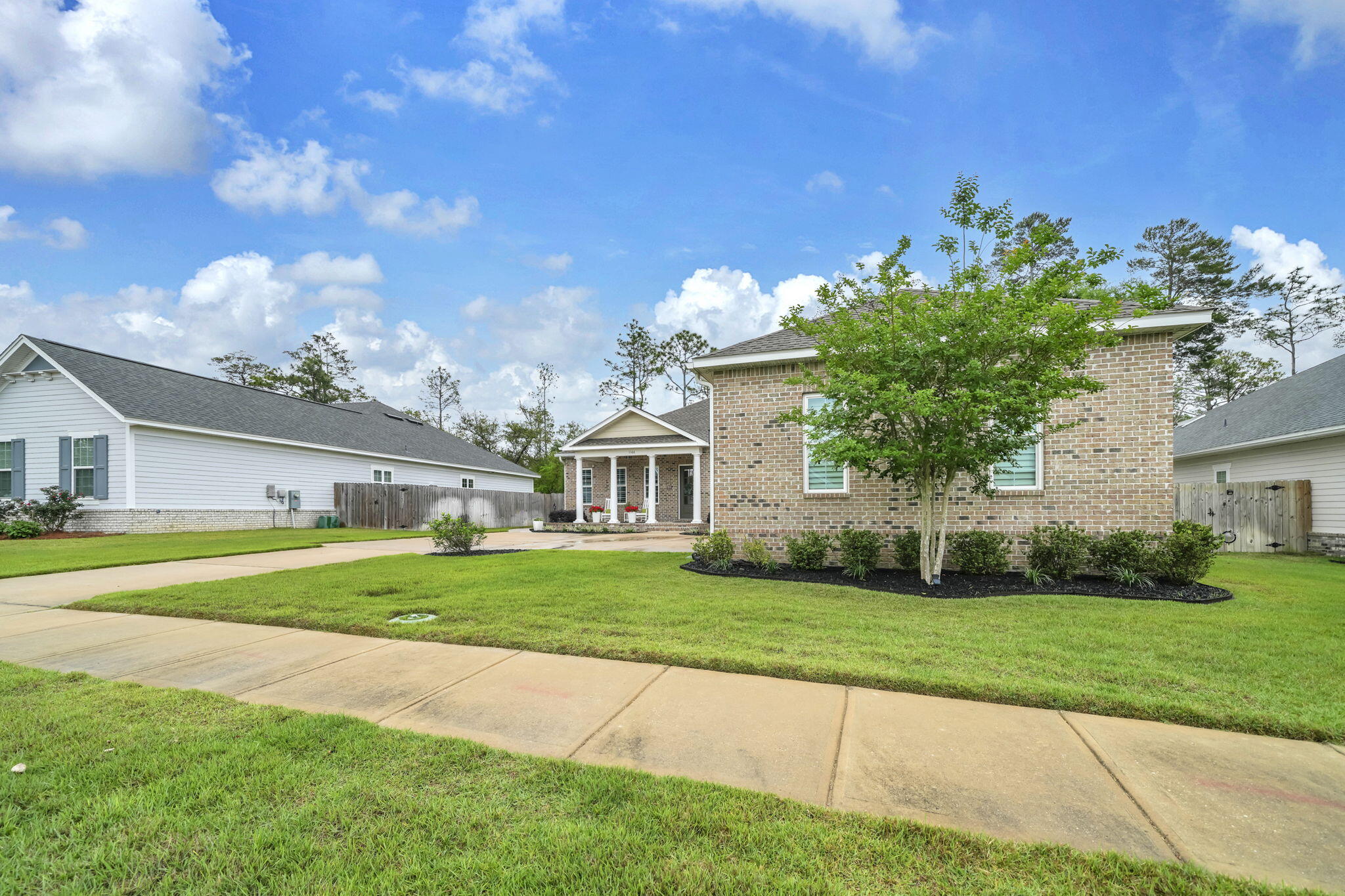 1166 Deer Moss Loop Niceville, FL 32578 - Photo 4 of 46 a front view of a house with a yard