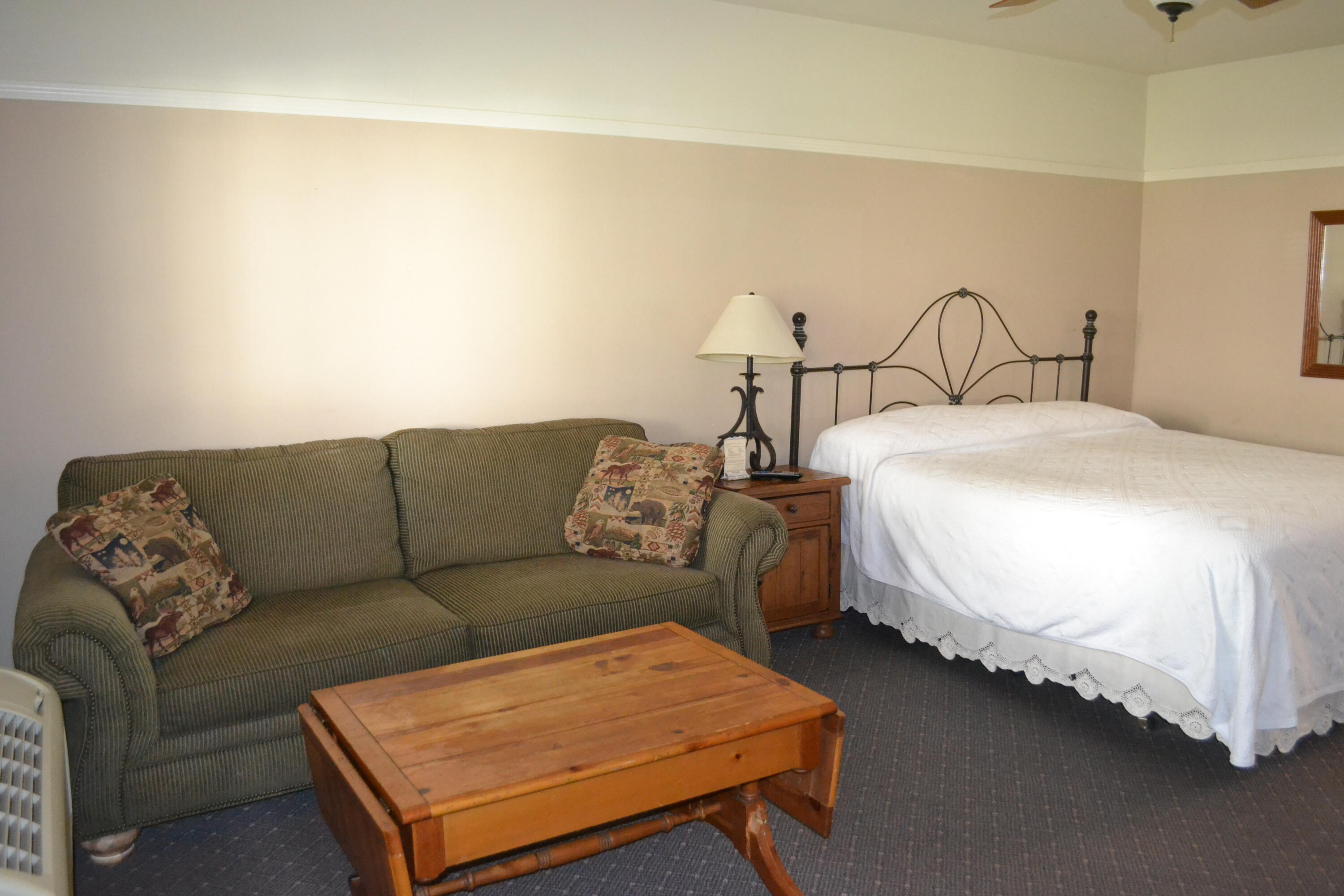 24860 Main Street Fall River Mills, CA 96028 - Photo 23 of 50 a bedroom with bed and a couch