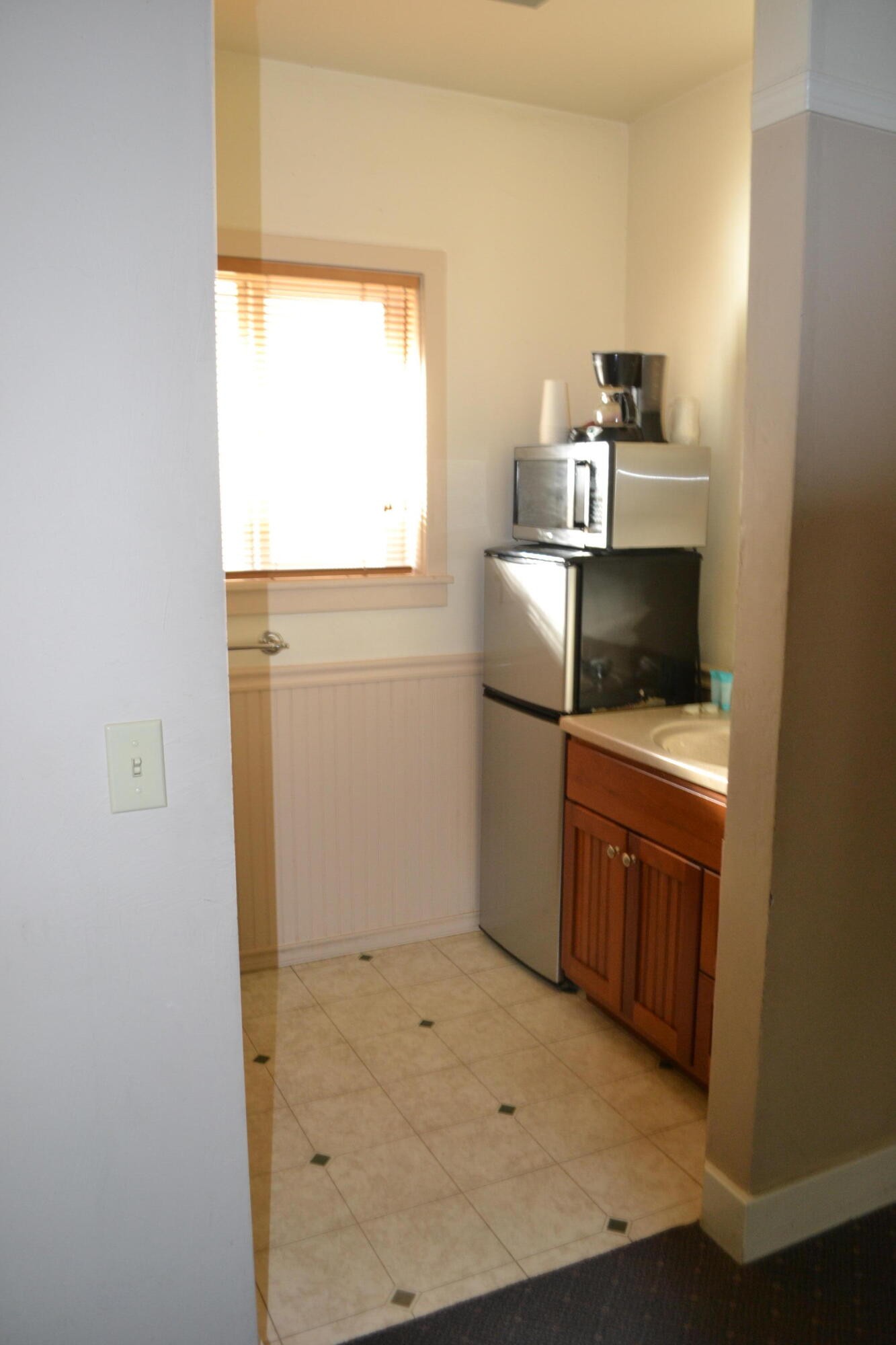 24860 Main Street Fall River Mills, CA 96028 - Photo 24 of 50 a kitchen with cabinets and window