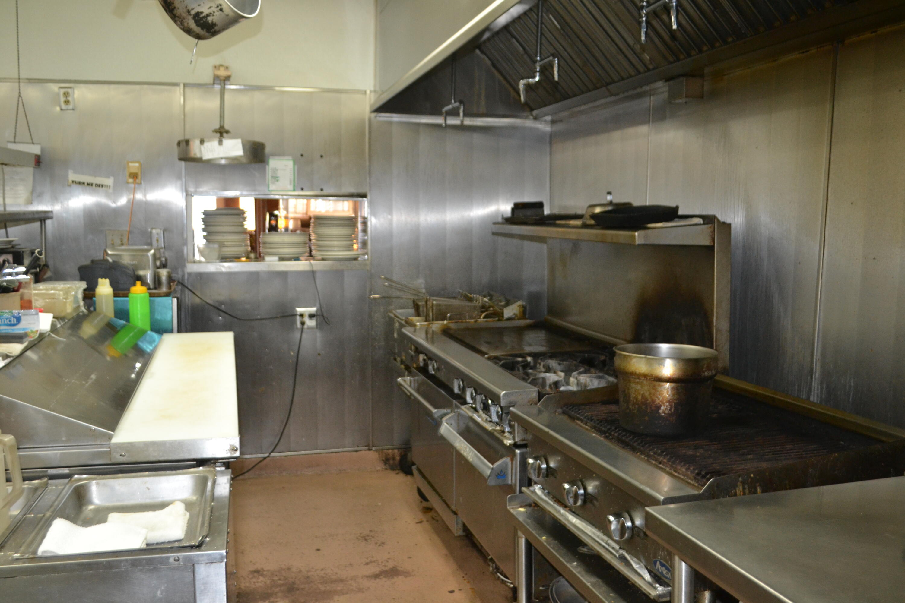 24860 Main Street Fall River Mills, CA 96028 - Photo 27 of 50 a stove top oven sitting inside of a kitchen