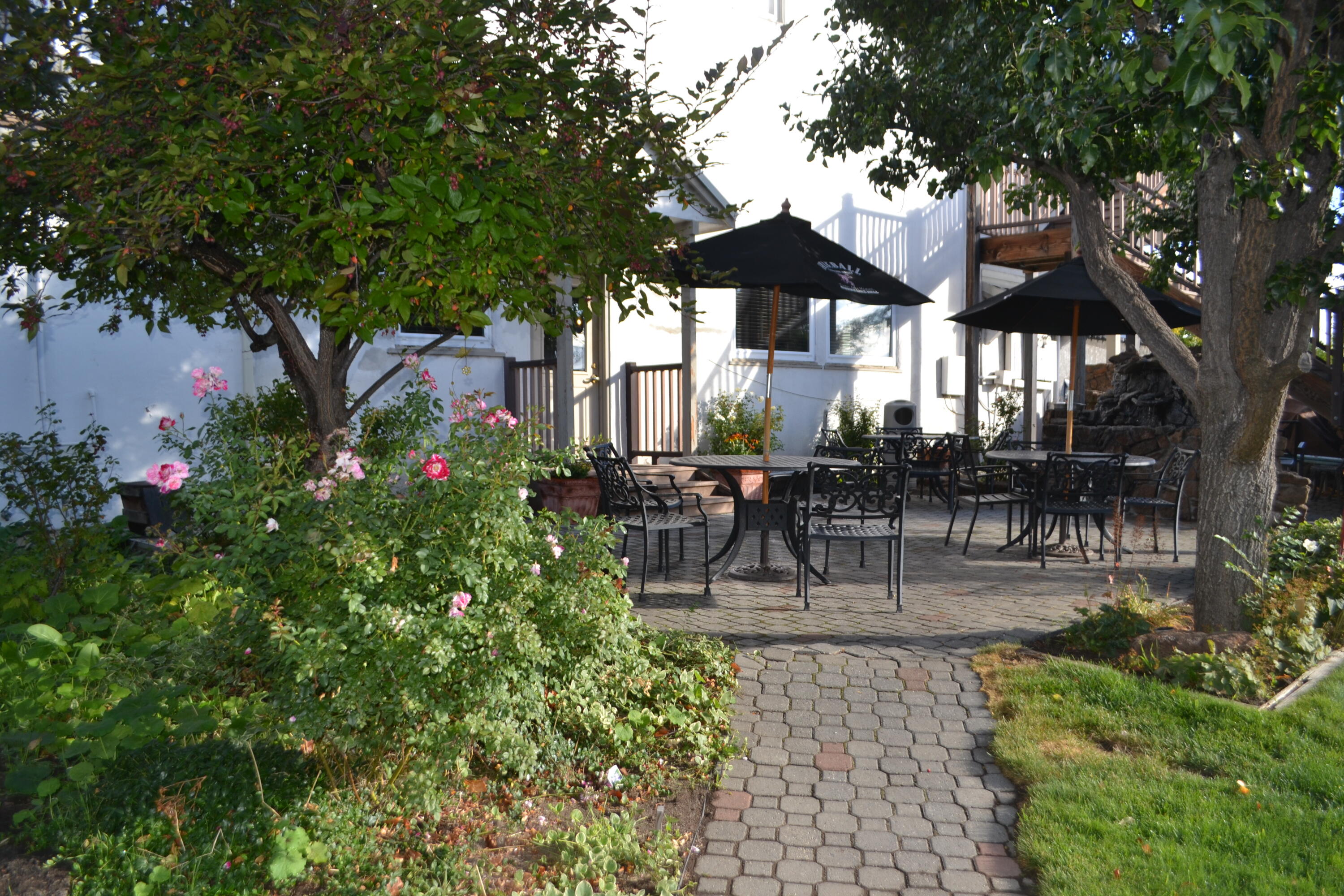 24860 Main Street Fall River Mills, CA 96028 - Photo 33 of 50 a view of a patio with a table and chairs under an umbrella