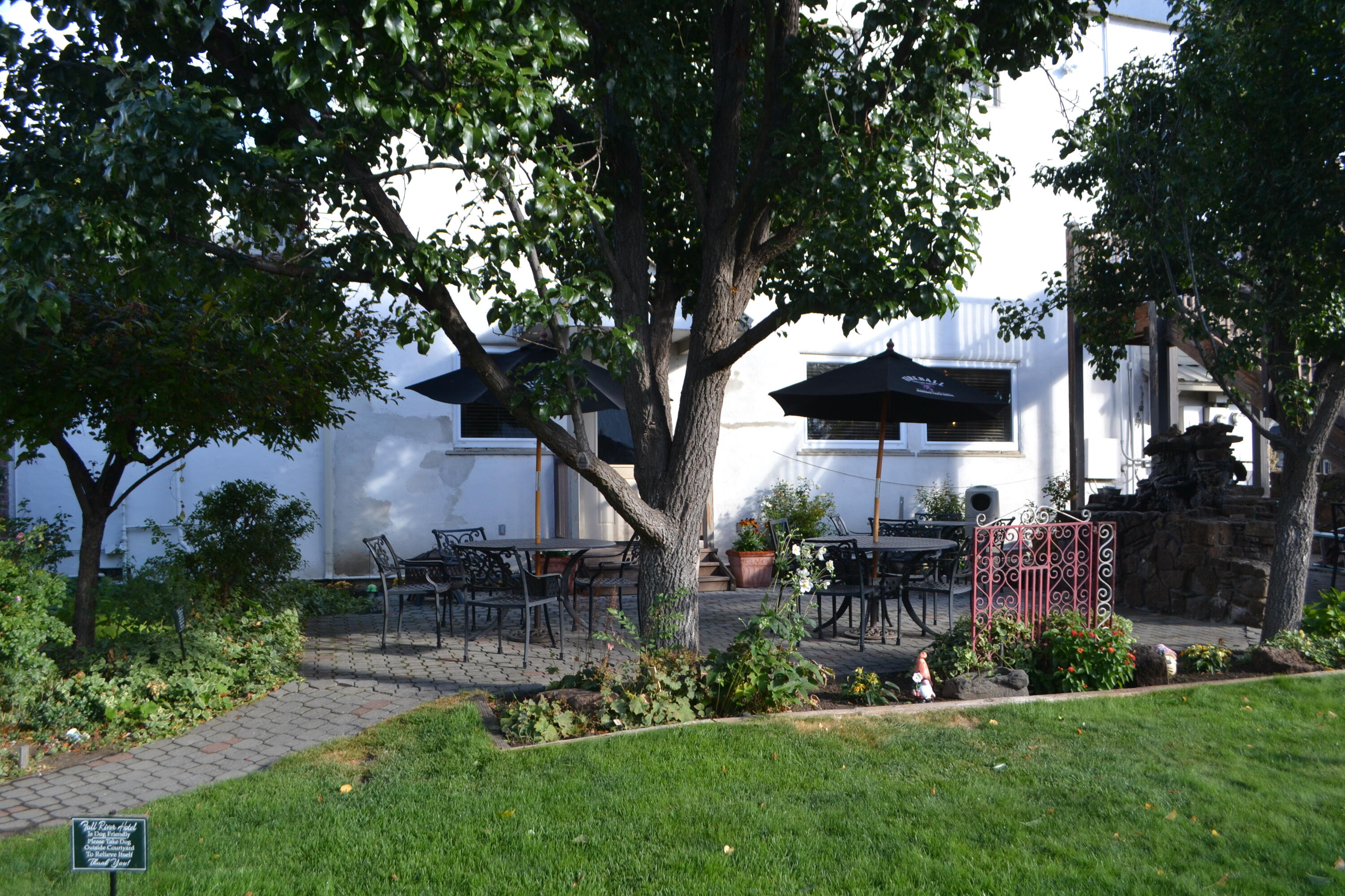 24860 Main Street Fall River Mills, CA 96028 - Photo 36 of 50 a front view of a house with a yard fire pit and large trees