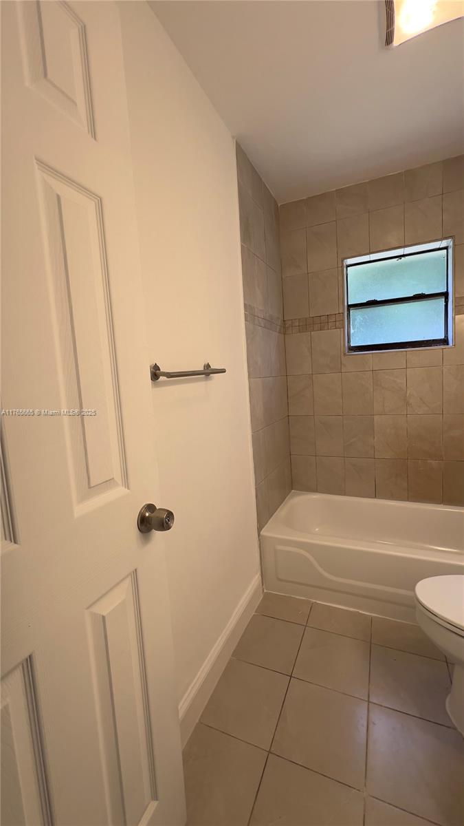 2008 North 47th Street Fort Pierce, FL 34947 - Photo 12 of 27 a bathroom with a bathtub and a shower
