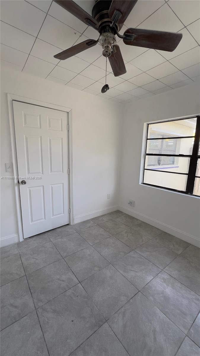 2008 North 47th Street Fort Pierce, FL 34947 - Photo 21 of 27 a view of a room with a ceiling fan and window