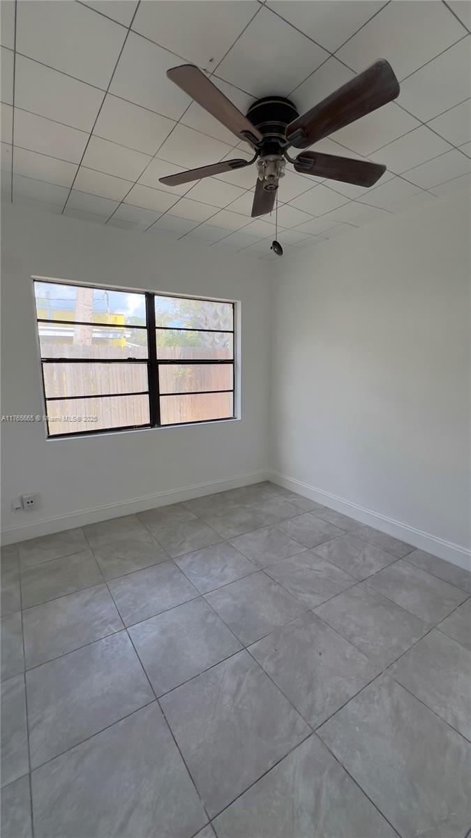 2008 North 47th Street Fort Pierce, FL 34947 - Photo 22 of 27 a view of a livingroom with a ceiling fan and window
