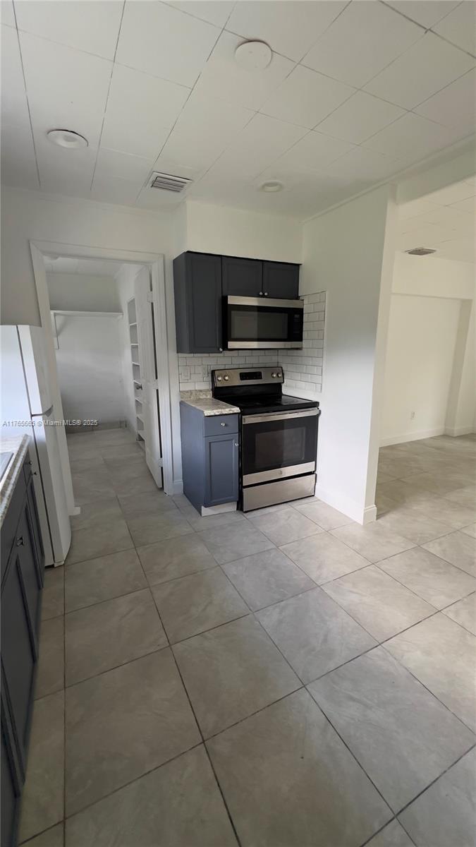 2008 North 47th Street Fort Pierce, FL 34947 - Photo 4 of 27 a living room with stainless steel appliances and furniture