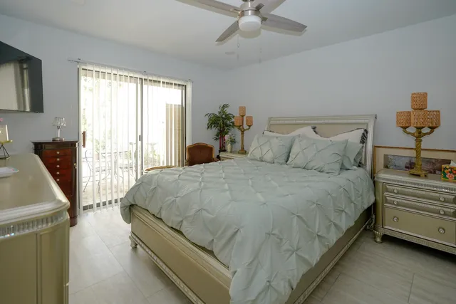 a large bed sitting in a bedroom next to a window