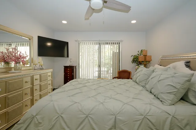 a large bedroom with a bed and a flat screen tv