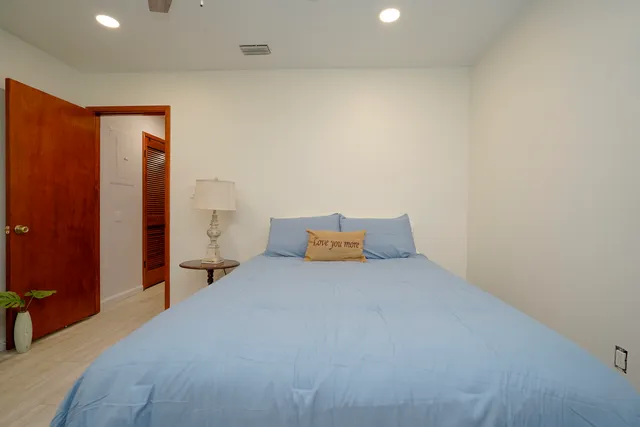 a large bedroom with a bed and a closet