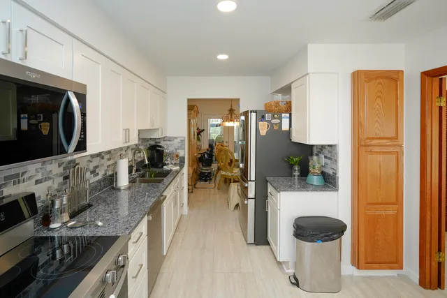 a kitchen with sink and refrigerator
