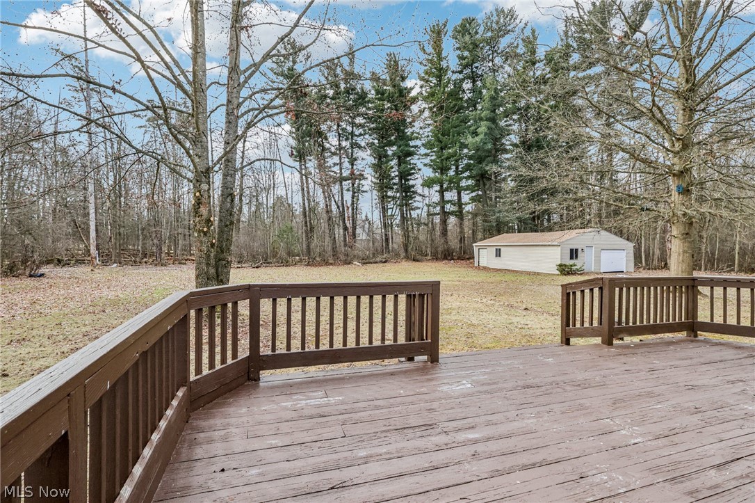 2829 Tibbetts Wick Road Hubbard, OH 44425 - Photo 32 of 44 Wooden terrace featuring an outdoor structure and a lawn