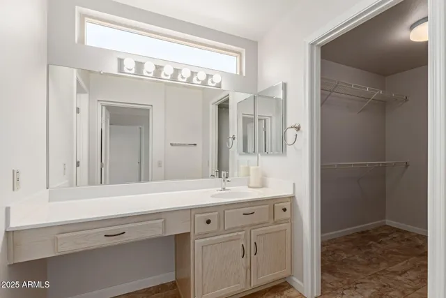 a bathroom with a sink a mirror and a shower