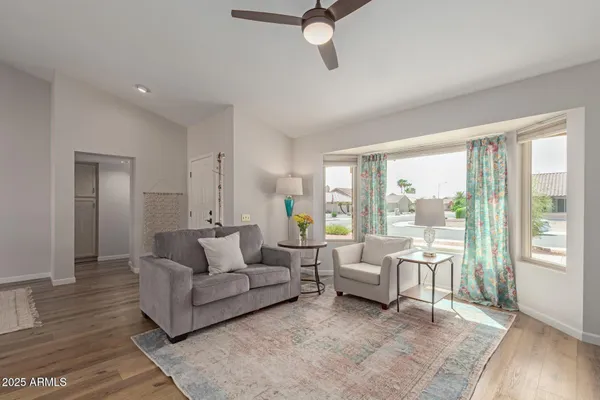 a living room with furniture and a large window