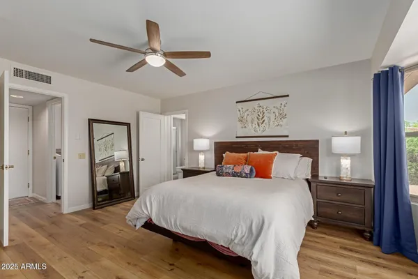 a bedroom with a bed and wooden floor