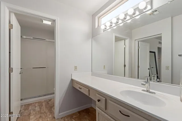a bathroom with a sink a vanity and a mirror