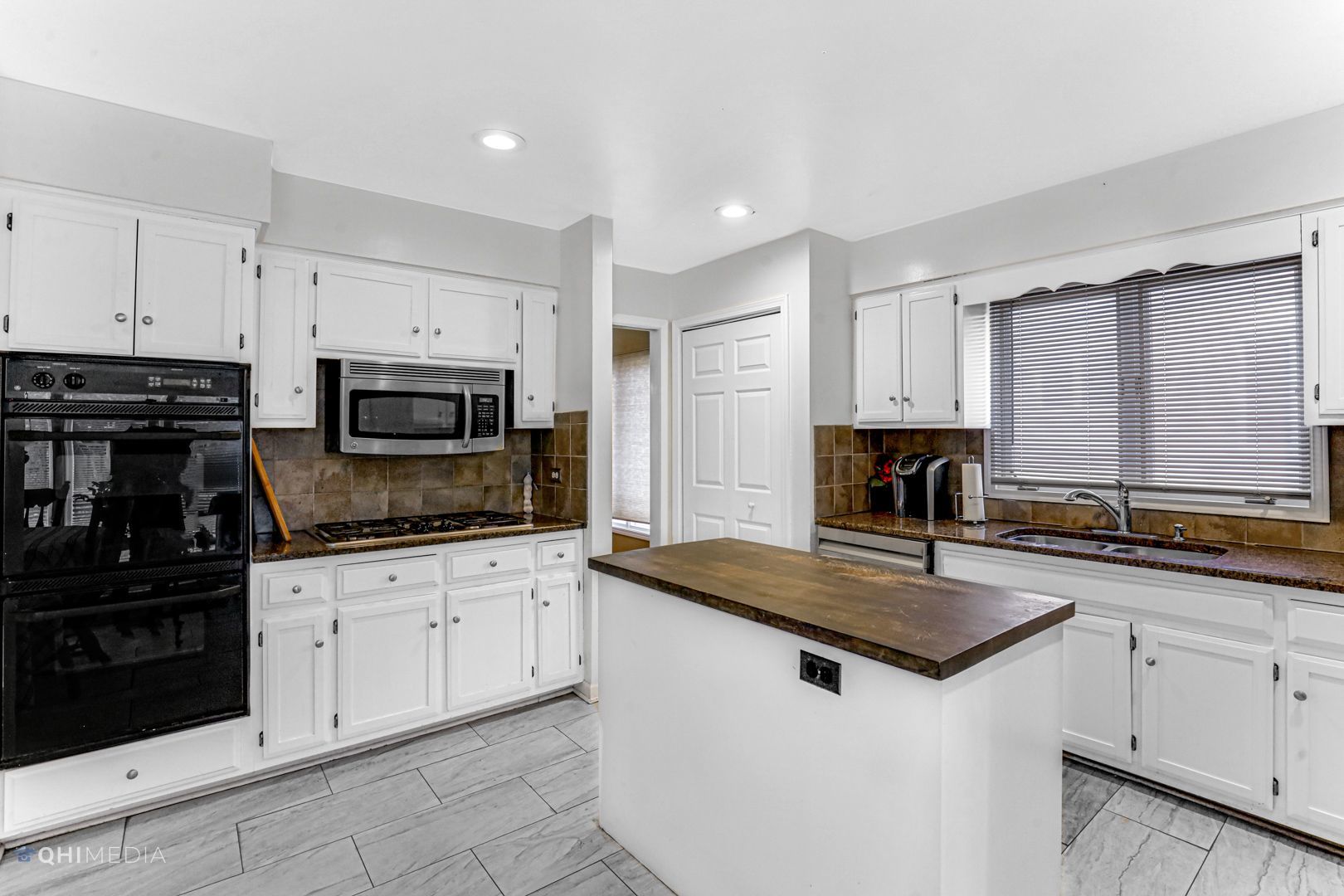 2930 Paris Road Olympia Fields, IL 60461 - Photo 6 of 27 a kitchen with granite countertop white cabinets sink and stainless steel appliances