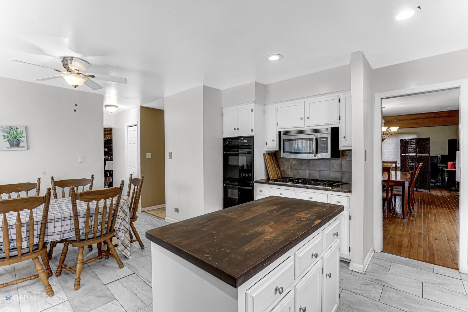 2930 Paris Road Olympia Fields, IL 60461 - Photo 8 of 27 a kitchen with stainless steel appliances granite countertop a table chairs sink and cabinets