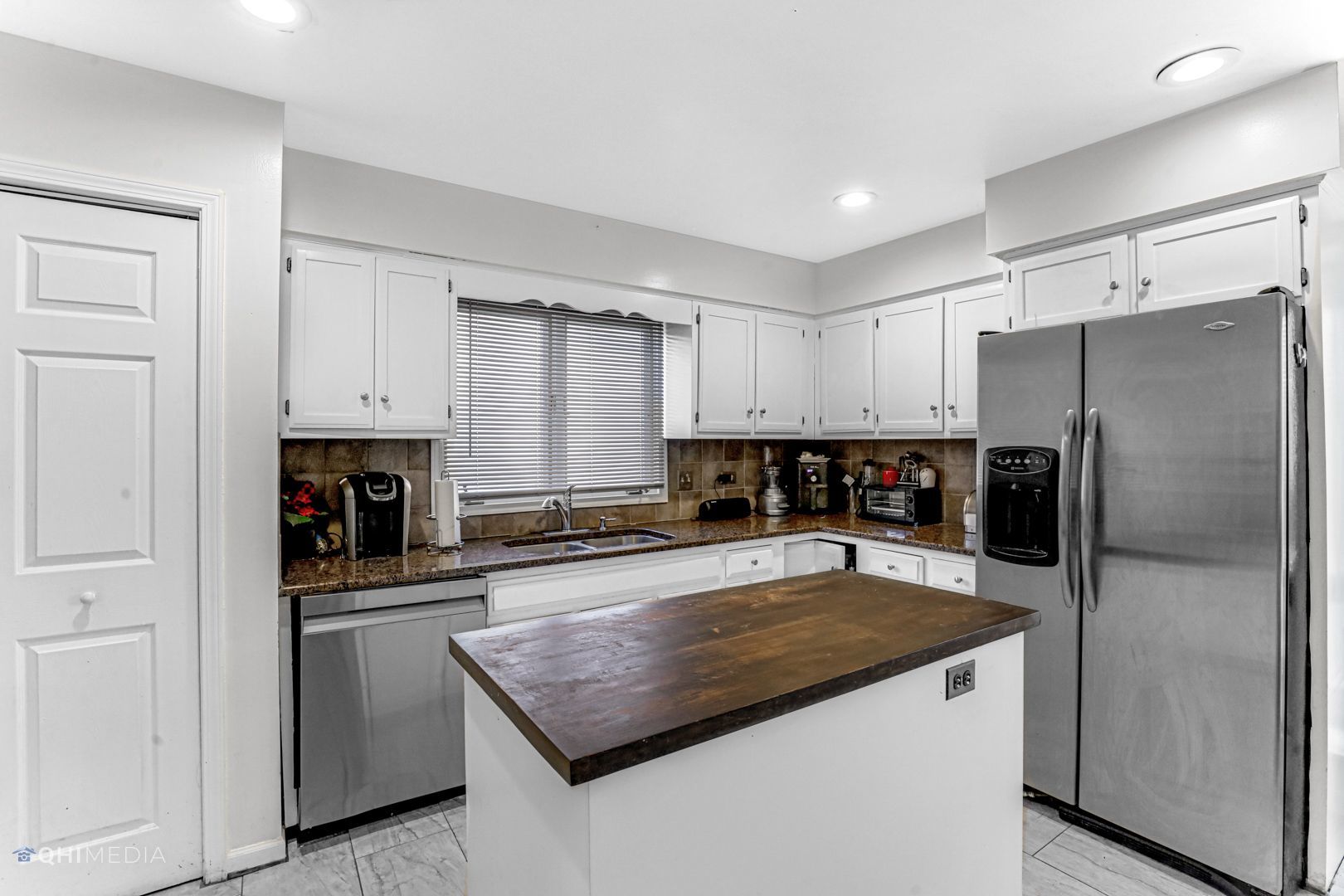 2930 Paris Road Olympia Fields, IL 60461 - Photo 9 of 27 a kitchen with stainless steel appliances a refrigerator sink and white cabinets