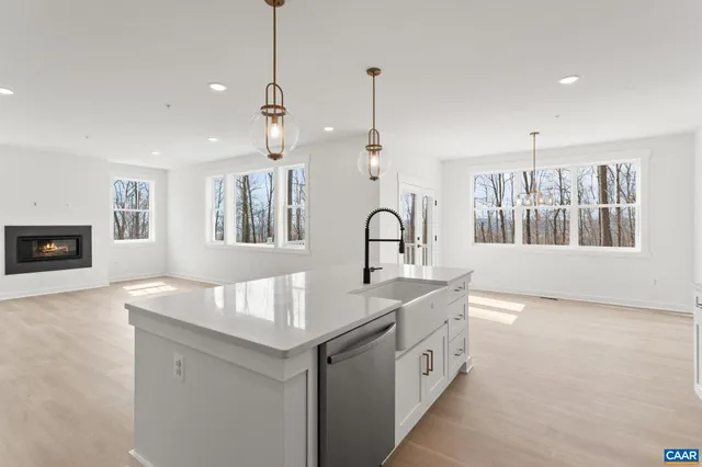 a kitchen that has a sink a stove and a window