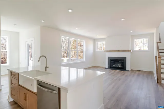 a view of kitchen with sink and fireplace